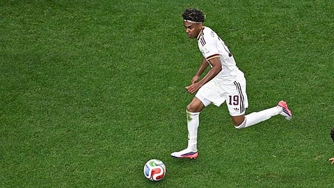 Spain's Lamine Yamal (19) runs with the ball among Portugal's Nelson Semedo (2) and Joao Neves (15) during the World Cup
