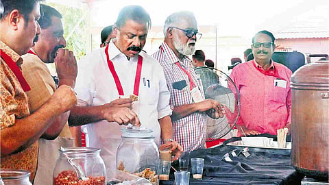 CPM state secretary M V Govindan having refreshments from a tea stall set up near the venue of the extended state committee meet in Kozhikode