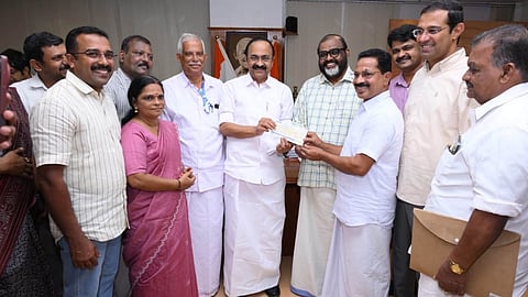 Jose handing over the cheque for Rs 40 lakh to the Chief Minister