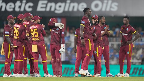 West Indies' Jayden Seales, fourth right, celebrates with his teammates after taking the wicket of India's Rohit Sharma  