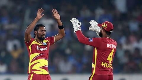 Keemo Paul celebrates a wicket with Shai Hope
