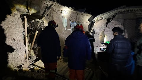 In this photo released by Xinhua News Agency, firefighters inspect an earthquake-hit village houses in Baqen County of Nagqu City in China's Tibet autonomous region, on Friday 