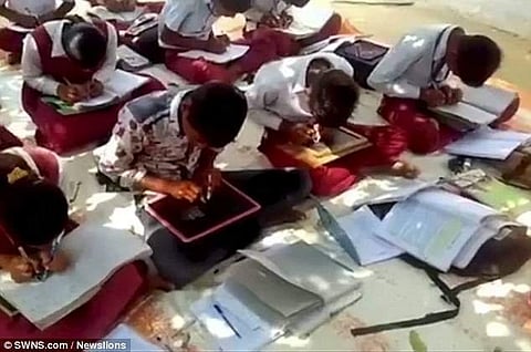 students  writing on slate