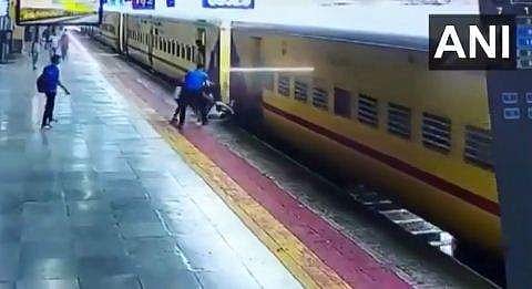 ഓടുന്ന ട്രെയിനില്‍ ചാടിക്കയറാന്‍ ശ്രമിക്കുന്നതിനിടെ വീണ യുവതി രക്ഷിക്കുന്നു, എഎന്‍ഐ
