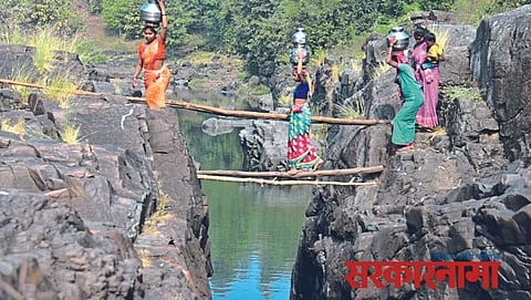 Womens walking on wood pole for water