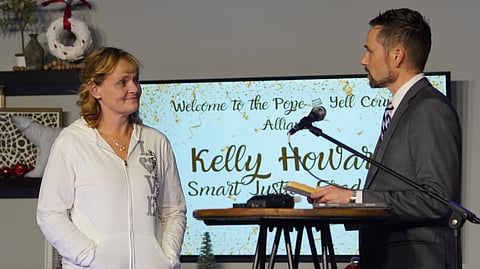Kelly Howard receives her graduation certificate from Judge Clayton McCall after she completed all requirements of the Smart Justice District Court Initiative.