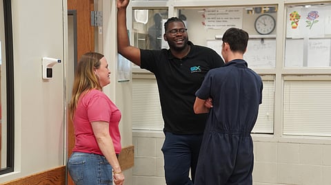 Crystal Davis and Bradley Burrell of Exodus.Life talk to a
juvenile at the detention center shortly before the life skills class begins.