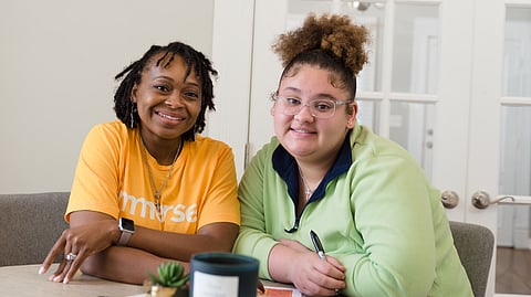 An Immerse Arkansas coach and teen at a weekly meeting