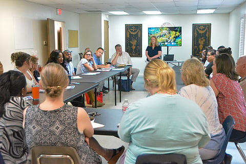 Whitney Fraley, coordinator for 100 Families of Craighead County, facilitates a community meeting about legal challenges families face.