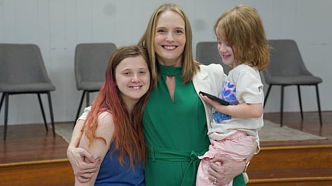 Deanna Walderns of the 100 Families Initiative of Pulaski County shares an embrace with a family she has supported on their journey toward stability.