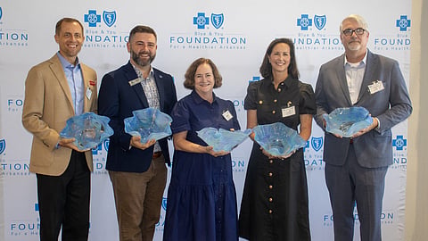 Paul Chapman (Restore Hope) and fellow community leaders accept Innovation in Action from the Blue & You Foundation for a Healthier Arkansas.