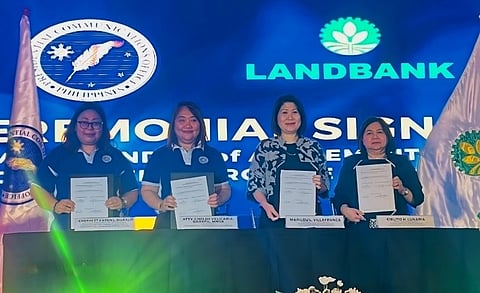 PCO Secretary Atty. Cheloy Velicaria-Garafil, MNSA (2nd from left) and LANDBANK Senior Vice President Marilou L. Villafranca (3rd from left) lead the signing of a Memorandum of Agreement for the Government Purchase Card (GPC) Program on 11 October 2023, at the Palacio de Maynila in Malate, Manila. They were joined by PCO Undersecretary Cherbett Karen L. Maralit (leftmost) and LANDBANK First Vice President Cielito H. Lunaria (rightmost).