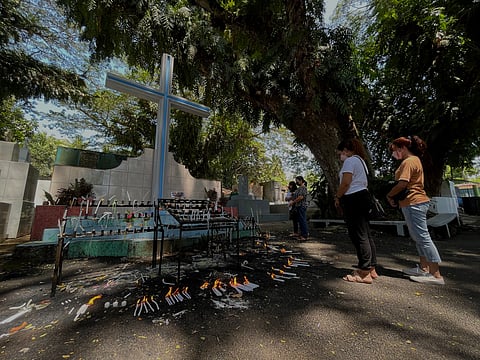 LIGHT A CANDLE. While many choose to flock to cemeteries during "Undas", some opt to light candles and visit their dearly departed at the cemeteries to avoid the "All Saints' Day and All Souls' Day" rush. In this photo, Dabawenyos were seen lighting candles at the Mintal Public Cemetery before Nov. 1 and 2. 