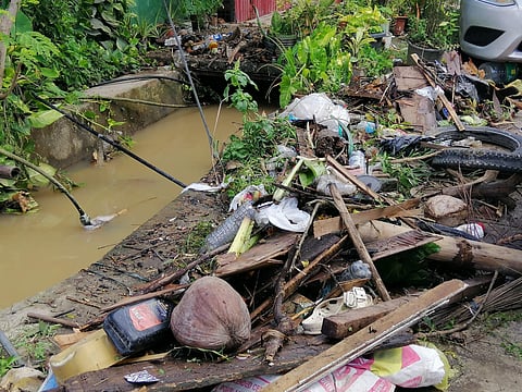 Residents of Talusa, Barangay Talomo Proper are declogging the canals to help the floodwater subside faster, Thursday morning, November 9, following the heavy downpour last night.