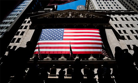 People walk past the New York Stock Exchange on Wednesday, June 29, 2022 in New York. Wall Street’s best week of the year is getting even better Friday, Nov. 3, 2023, following a cooler-than-expected report on the job market.