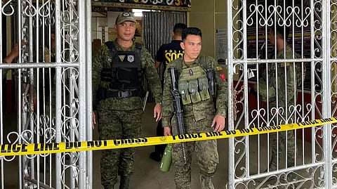 Military personnel stand guard at the entrance of a gymnasium after a bomb attack at Mindanao State University in Marawi, Lanao del sur province on December 3, 2023.