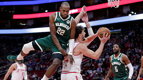NOTHING YOU CAN DO. Milwaukee Bucks forward Khris Middleton (No. 22) fouls Houston Rockets center Alperen Sengun in an NBA regular season game in Houston, Texas. / 
