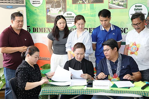 E. B. Magalona Town Mayor Marvin Malacon leads his siblings in the surging of the deed of donation for the 1.8-hectare property they donated to Carlos Hilado Memorial State University (CHin Talisay City on February 7.
