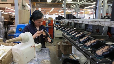 FILE - A woman works in a shoe maquiladora or factory in Leon, Mexico, Feb. 7, 2023. For the first time in more than two decades, Mexico last year overtook China as America's top supplier of goods — a shift that reflects political tensions between Washington and Beijing and U.S. efforts to import from countries that are friendlier and closer to home. 