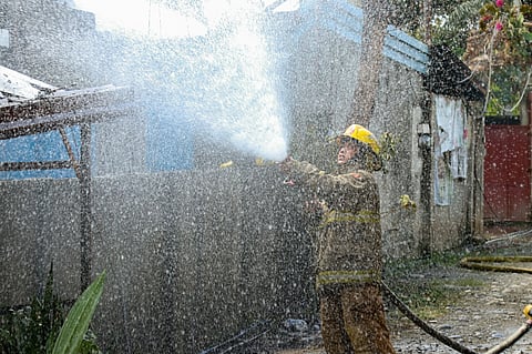 A fire personnel from the Bureau of Fire Protection responded to a fire that broke out at Sunflower St., Ecoland Subdivision, Davao City on January 8, 2024.