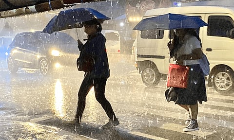 RAINY AFTERNOON. Most parts of Davao City experienced heavy rains late in the afternoon on September 28, 2022 caused by the Southwest Monsoon. Several parts of the city experienced heavy traffic and flooding. In this photo, pedestrians quickly cross the road along Corner Jerome, R. Castillo Street during the heavy rain.