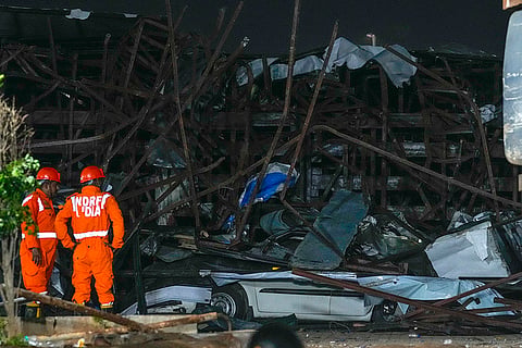 Rescuers look for victims under a billboard that collapsed following heavy rain and thundershowers in Mumbai, India, Monday, May 13, 2024. Scores of people were thought to be trapped after the collapse in the suburb of Ghatkopar, Mumbai police said on social media platform X. 