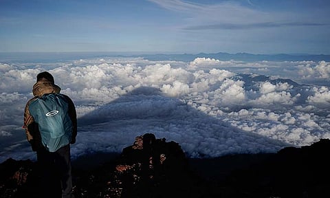 The shadow of Mount Fuji is cast on clouds hanging below the summit Aug. 27, 2019, in Japan. Three bodies were found inside a crater at the summit of Mount Fuji, Japan’s most famous mountain, with one of them already brought down from the slopes, police said Thursday, June 27, 2024. 