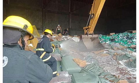 ZAMBOANGA. The Bureau of Customs leads the destruction of some P595.22 million worth of smuggled cigarettes in Zamboanga City on Thursday, June 13. A photo handout shows firemen drenched in water while heavy equipment repeatedly crushed the cigarettes, which were later disposed of at the sanitary landfill of the city government. 