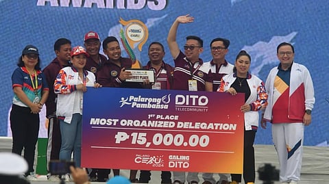 DAVAO 4TH OVERALL. Department of Education (DepEd) Davao regional director Allan Farnazo (wearing shades) receives the cash prize and trophy for the most organized  delegation. Davao also finished fourth overall in the Palarong Pambansa 2024 that concluded in Cebu City on Tuesday, July 16. 
