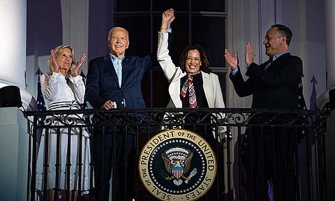 First lady Jill Biden, left, and second gentleman Douglass Emhoff, right, watch as President Joe Biden, center left, raises the hand of Vice President Kamala Harris as they view the Independence Day firework display over the National Mall from the balcony of the White House, July 4, 2024, in Washington. She's already broken barriers, and now Harris could soon become the first Black woman to head a major party's presidential ticket after President Joe Biden's ended his reelection bid. The 59-year-old Harris was endorsed by Biden on Sunday, July 21, after he stepped aside amid widespread concerns about the viability of his candidacy. 