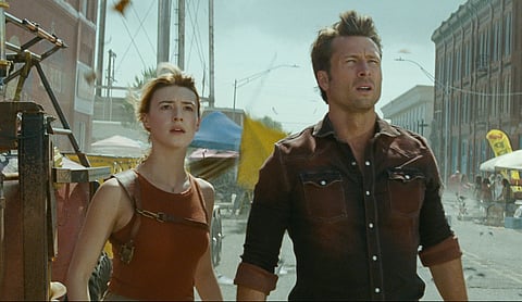 This image released by Universal Pictures shows Glen Powell, right, and Daisy Edgar-Jones in a scene from "Twisters."
