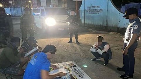 ZAMBOANGA. Authorities arrest a high-value individual (HVI) and seize some P13.6 million worth of illegal drugs in an anti-drug operation in San Roque, Zamboanga City on Friday, August 9, 2024. A photo handout shows policemen watched as inventory of the confiscated evidence is being processed in front of the arrested suspect (seated, right) (SunStar Zamboanga)