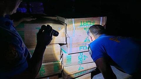 ZAMBOANGA. Policemen arrest five suspects and seize some P630,000 worth of smuggled cigarettes and two vehicles in a law enforcement operation in Maguindanao del Norte on Wednesday, August 14, 2024. A photo handout shows policemen inspecting the confiscated master cases they seized during the checkpoint operation. (SunStar Zamboanga)
