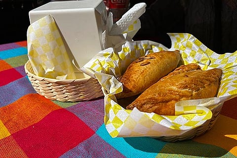 A basket of Mexican pastes sit on a patron's table before they are eated for lunch at the 16th International Paste Festival in Mineral del Monte, Mexico, Saturday, Oct. 12, 2024. 