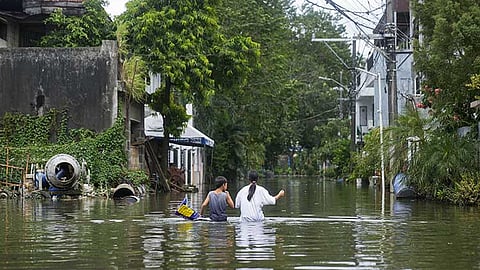 RIZAL. Residents walk along the flooded village caused by Tropical Storm Kristine (Trami) on Friday, October 25, 2024, in Cainta, Rizal province, Philippines.