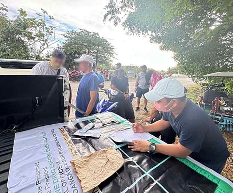 ZAMBOANGA. Authorities have arrested one suspect and seized P340,000 worth of illegal drugs in an anti-drug operation on Wednesday, March 19, in Militar village, Tukuran, Zamboanga del Sur. A photo handout shows an agent of the Philippine Drug Enforcement Agency conducting an inventory of the pieces of evidence they seized from the suspect (seated on a motorcycle). 
