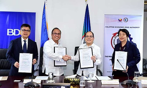Promoting Global Investment Opportunities in the PH. Charles M. Rodriguez (2nd from left), Executive Vice President and Head of Institutional Banking Group of BDO Unibank, and Tereso O. Panga (3rd), Director General of Philippine Economic Zone Authority (PEZA) shake hands after the MOU signing. Joining them are Romeo R. Co, Jr. (leftmost), Senior Vice President and Department Head of Financial Institutions and International Desks of BDO Unibank, and Maria Veronica F Magsino (rightmost), Deputy Director General of PEZA.