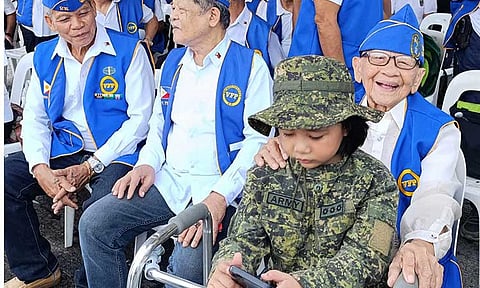 ‘MY MIRROR YEARS AGO’.
Teofilo “Lolo Pilo” Gamutan, a 104-year-old World War II veteran, church servant, and music lover, poses with his five-year-old great-grandchild, Coleen, on Wednesday, April 9, 2025, at the Veterans Memorial Monument in Davao City. 