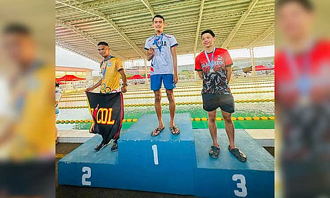 SWIMMING CHAMPION. DMMA College of Southern Philippines swimmer Ahbsfar Saggap, center,  celebrates after winning the gold medal in the senior men’s 200-meter breaststroke
at the 2025 National Private Schools Athletic Association (Prisaa) Games in Tuguegarao City. 