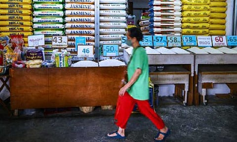 RICE RETAIL PRICES. A consumer passes by a rice stall at Kamuning Public Market in Quezon City on March 18, 2025. The Department of Agriculture on Friday (June 13) said prices of retail rice may further dip in the local markets with the target lowering of the maximum suggested retail price of rice for rice and Rice For All (RFA) varieties in July. (PNA photo by Joan Bondoc)