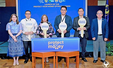 The Financial Sector Forum (FSF) launches the 2025 ‘Protect Your Money’ (PYM) information campaign to empower financial consumers and combat scams. Joining the launch on June 17, 2025 at the Bangko Sentral ng Pilipinas (BSP) head office in Manila are (from left) BSP Deputy Governor Bernadette Romulo-Puyat, Insurance Commission’s Juan Paolo Roxas, BSP Deputy Governor Chuchi Fonacier, Securities and Exchange Commission assistant director Paolo Cruz, Philippine Deposit Insurance Corp. president Roberto Tan and corporate affairs vice president Jose Villaret Jr.