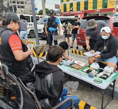 ZAMBOANGA. Lawmen arrest a high-value target (HVT) suspect (seated, back to the camera) and seize some P13.6 million worth of suspected shabu in anti-illegal
drug on Sunday, August 24, in Tubod village, Iligan City, Lanao del Norte.