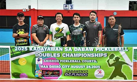 PICKLEBALL CHAMPS. Cotabato City pair Ahmil Hussein “Kaka Jeng” Ampatuan Macapendeg, third from left,  and Sigmond Escalona, fourth from left, receive their prizes from the Sports Development Division of the City Mayor’s Office (SDD-CMO) personnel for clinching the intermediate title of the 2025 Kadayawan sa Dabaw Pickleball Doubles Championships at Crisron Pickleball Court in Maa, Davao City, on Sunday, August 24. Also in the photo is tournament director Juanito “Titong” Cansino. 