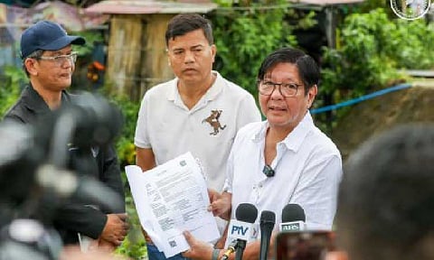 UNCOVERING THE TRUTH. President Ferdinand R. Marcos Jr. shows the media a copy of a report on the PHP55.7 million reinforced concrete riverwall project in Baliwag City, Bulacan on Aug. 20, 2025. Marcos said the creation of an independent body to investigate flood control anomalies would be finalized “very, very soon". (PCO photo)