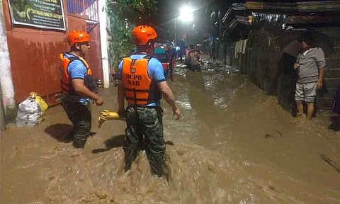Residents at Abayon Village in Calinan, Davao City are being evacuated by police personnel and other rescue auxiliaries as flood water continue to rise due to the rain on November 21, 2023.