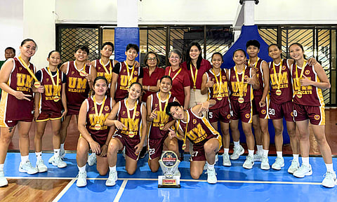 UM LADY WILDCATS. Players and coaches of the University of Mindanao (UM) Lady Wildcats celebrate winning the women’s basketball title of the Escandor Cup Inter-Collegiate Tournament 2025 at the Almendras Gym, Davao City Recreation Center.