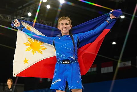 PINOY PRIDE. Charlie Ratcliff of the Philippines celebrates her girls’ mixed martial arts (MMA) gold medal win in the Asian Youth Games on Saturday, October 25, at Exhibition World Bahrain.