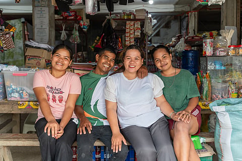 A REVITALIZED MOM-AND-POP STORE AT SITIO KIMAN-ANAO. After their sitio was connected to the grid, husband and wife tandem Boyet and Mary Jane Sampiano (center) upgraded their variety store with a refrigerator, piso Wi-Fi, and a printing and photocopying machine, effectively increasing their daily income.