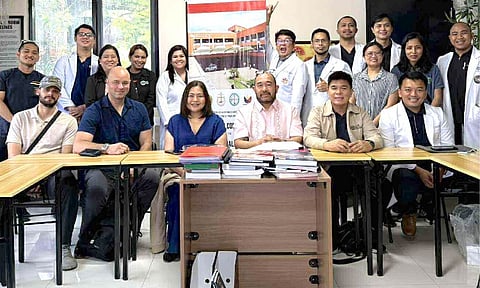 DAY IS DONE. The inspection team and the personnel pose for posterity after the grueling question and answer. 