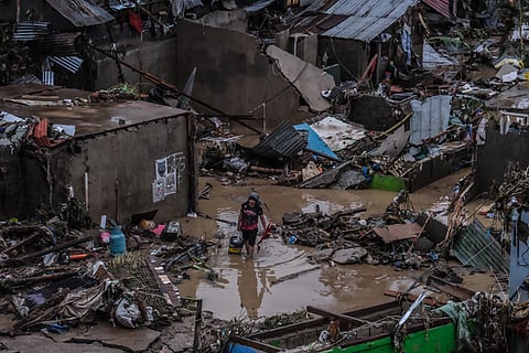SOAKED. A resident in Barangay San Isidro, Talisay City, attempts to salvage what remained after Typhoon Tino caused massive flooding on November 4, 2025. The typhoon's heavy rains made the Mananga River overflow and damaged and destroyed hundreds of houses in San Isidro. 